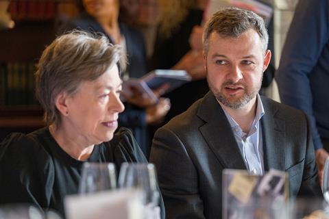 Photography of Insurance Fraud Enforcement Dept. City of London Police detective inspector Tom Hill talking at the roundtable. Medco Registration solutions director Susan Brown sits to his left listening.